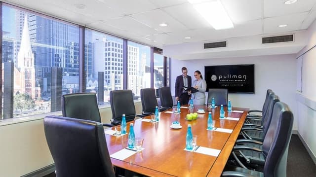 level-4-boardroom-1-with-team-members-and-logo_wide (1).jpg
