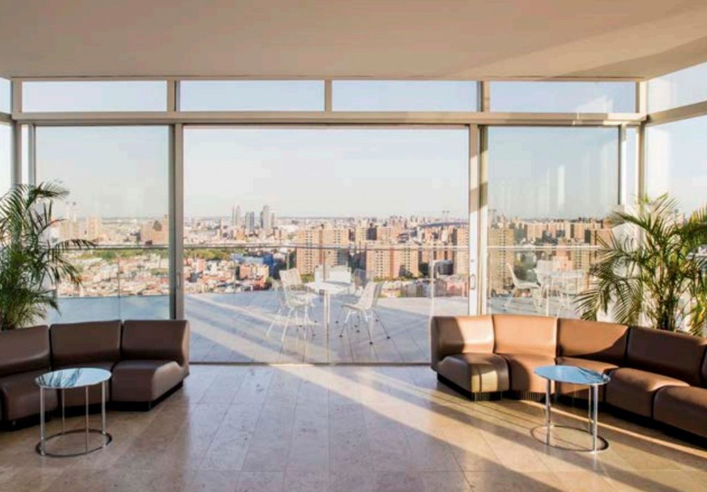 Indoor/outdoor Rooftop setting with view of downtown NYC